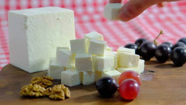 Cheese platter, Cubes of cheese, get cheese from plate. 4K UHD Video