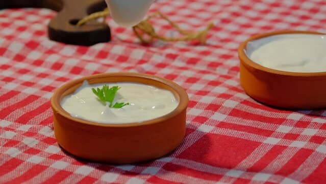 With spoon fresh yogurt close up.Mixing yogurt in bowl.4K UHD video