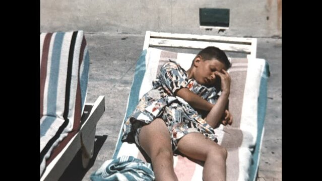 Lounging by the Pool 1957 - Brothers relax on lounge chairs beside a pool in Miami, Florida in 1957.