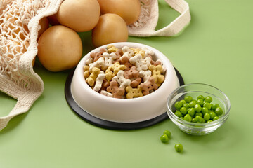 Dry dog vegan vegetarian food concept. Raw vegetables and green near bowl with pet feed