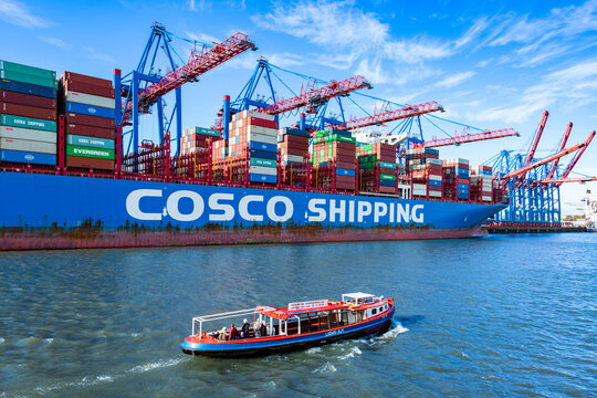 Container ship of Cosco Shipping Lines at Tollerort HHLA Terminal in Hamburg with the barge Ludwig Alm in the foreground October 24, 2022