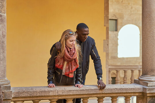 Diverse tourists hugging on balcony