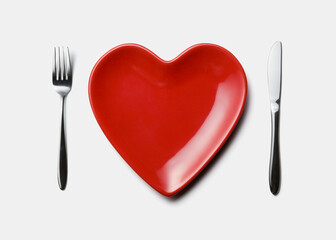 red heart shaped plate, fork and knife