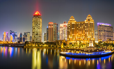 Panorama shot of Doha city buildings illuminated in colourful lights