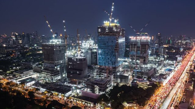 Day to night time-lapse of construction site, car traffic transportation on road in Asia city. Advanced building technology, busy downtown cityscape, developing industrial country concept