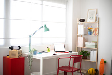 Cozy interior teenage person room with desk, chair and education supplies - Youth lifestyle concept