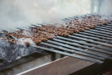 Adana kebabs grilled on a bbq, close up, street taste
