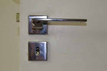 Lock and door handle made of silver metal