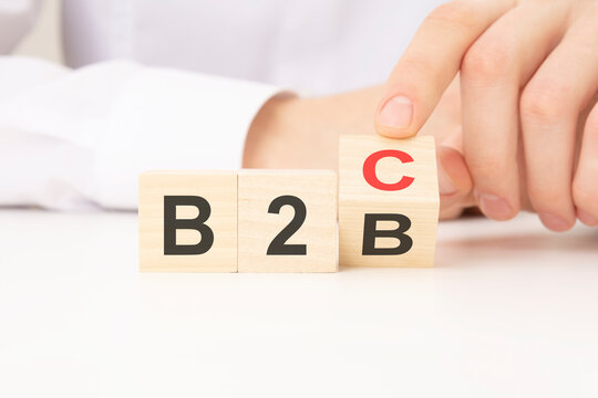 three wooden cubes with the letters B2B B2C in the hand on the white background. b2c is short for business to consumer. b2b short for business to business.