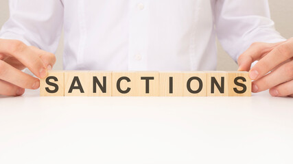 SANCTIONS word made with wooden building blocks. business and sell concept