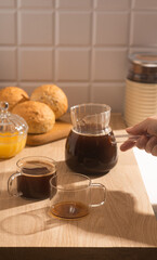 Americano in glass cups stands being poured from Turks