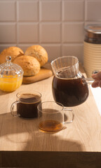 Americano in glass cups stands being poured from Turks
