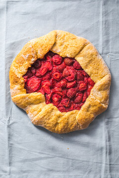 galetta with strawberries at home, top view on a blue background