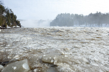 Chaudiere river and falls in winter, ice breaking up. Levis, Quebec. Canada