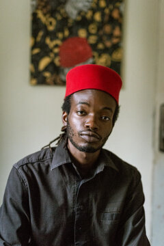 an igbo man posing for portraits in his native attire