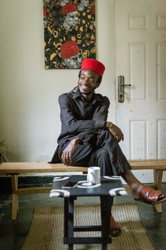 an igbo man posing for portraits in his native attire