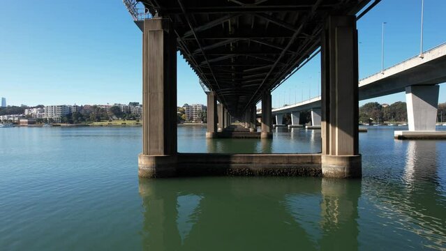 Drone-shot view under the Ryde Steel Bridge over the Parramatta River in Sydney, Australia
