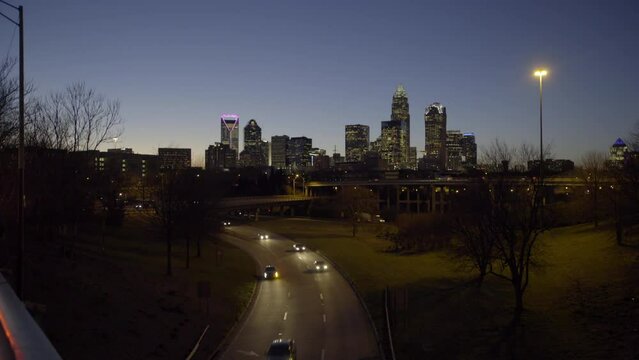 Lockdown Shot Of Cars Moving On Road By Modern Buildings In City Against Clear Sky At Dusk - Charlotte, North Carolina