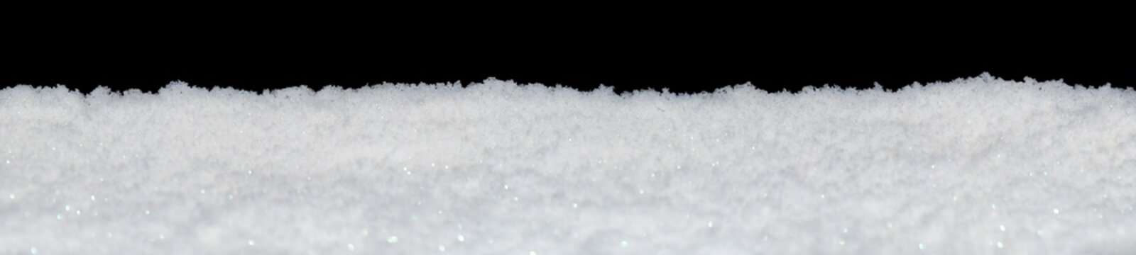 Banner of sparkling fluffy white snow isolated on black