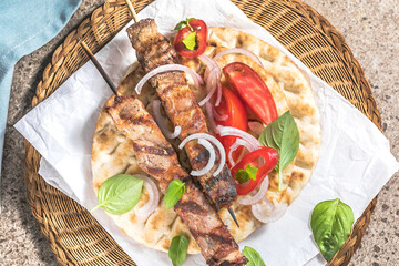 Pork souvlaki, kebabs on skewers with  salad and fresh home made tzatziki
