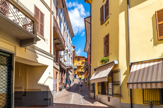 A colorful street of shops and cafes in the historic center of the lakefront town of Menaggio, Italy, on the shores of Lake Como.