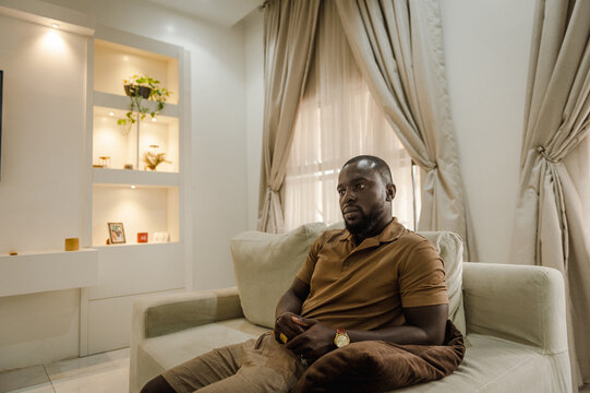 black man sitting on a sofa