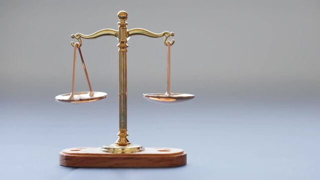 A Moving Bronze balance scale isolated or Weighing Balance Machine. Concept: Legal justice.