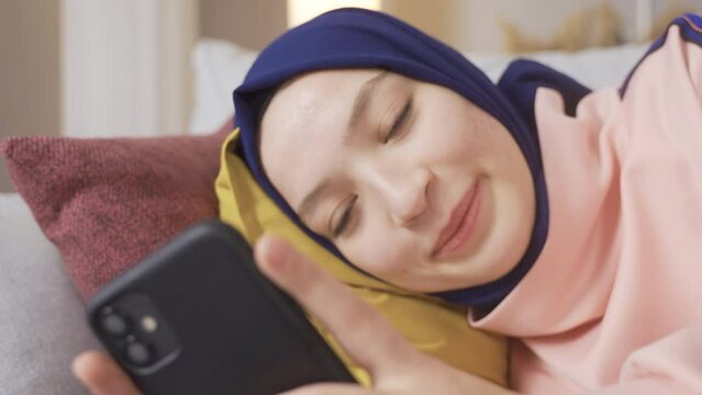 Muslim girl looking at her smartphone.
Successful female freelance manager or college student working at home or office.
