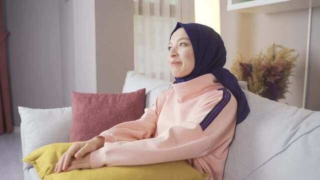 Muslim woman in hijab is dreaming, thinking, looking for ideas.
Muslim woman in hijab dreams at home.
