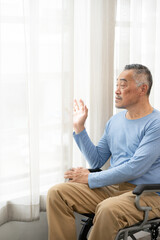 senior man sit in wheelchair look in distance feel lonely, thoughtful sad mature man in wheel chair thinking. suffering from loneliness, thinking of future.