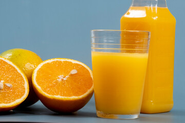 Natural orange juice in the glass with bottle on the side