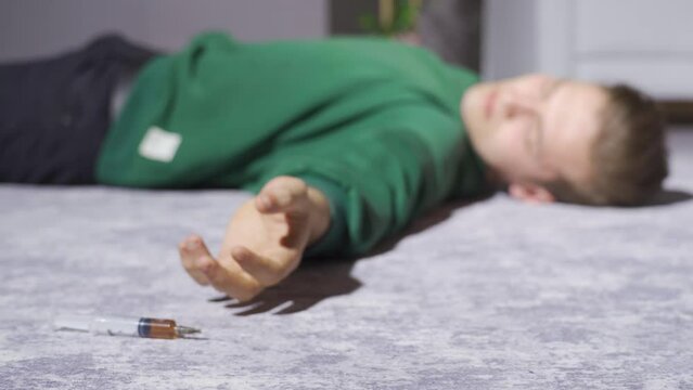 Drug addiction, high-dose drugs.
Man taking high dose drug from syringe.
