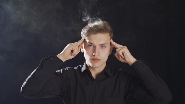 Smoke comes out of the head of the thoughtful teenager.
Smoke comes out of the head of the young man who thinks too much.

