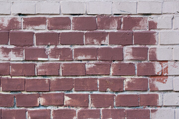 Obraz premium Old painted brick wall. Texture of rough brickwork. Masonry background.