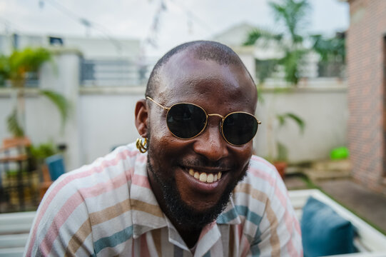 black man in sunglasses smiling