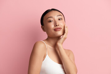 Tender Woman Touching Chick. Portrait of Positive Asian Woman Touching her Face and Smiling. Woman Appearance and Skin Care Concept 