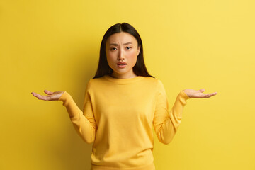 Confused Woman Shrugging Hands. Portrait of Uncertain Asian Girl Expressing Doubts and...