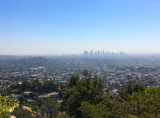 Fototapeta premium Skyline of Los Angeles in the far distance as seen from the Griffith Observatory
