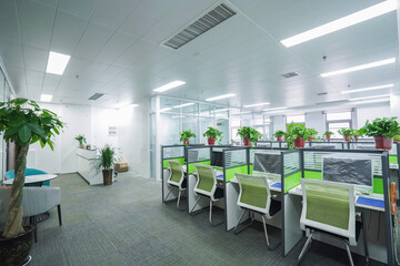 Interior office cubicles with computers and chairs