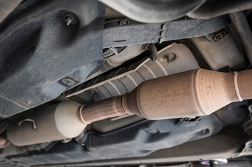 Close-up of catalytic converter in automobile exhaust system.
