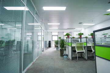 Interior office cubicles with computers and chairs