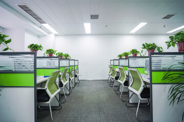 Interior office cubicles with computers and chairs