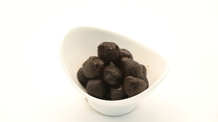black garlic in a white cup