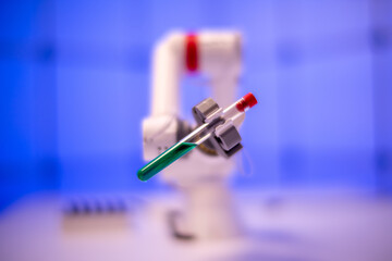 Robot take a test tube with a liquid. Laboratory of poisonous and hazardous chemicals