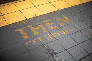 New York City, New York, USA - December 22 2021: New York subway safe reminding sign on the ground.