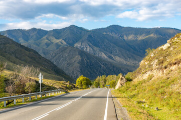 A road surrounded by mountains in the Altai Republic. Gorny Altai