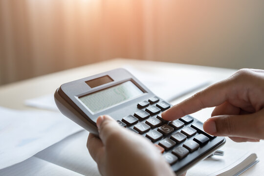 Woman calculate bill budget payment, home accounting concept with calculator.