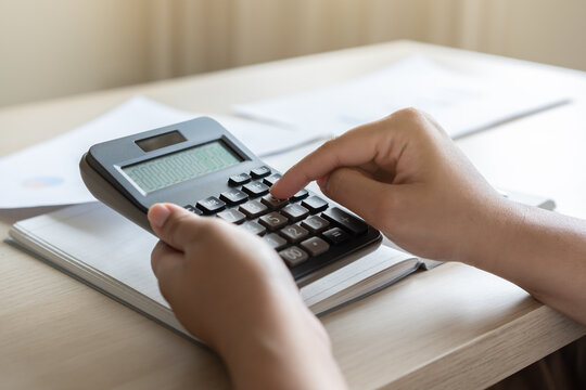 Woman calculate bill budget payment, home accounting concept with calculator.