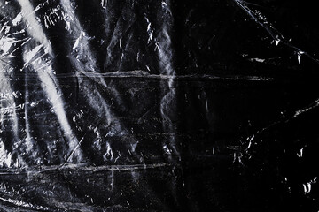black cellophane bag close-up background texture of plastic