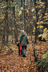 Girl walk in autumn forest with a dog. Healthy lifestyle concept